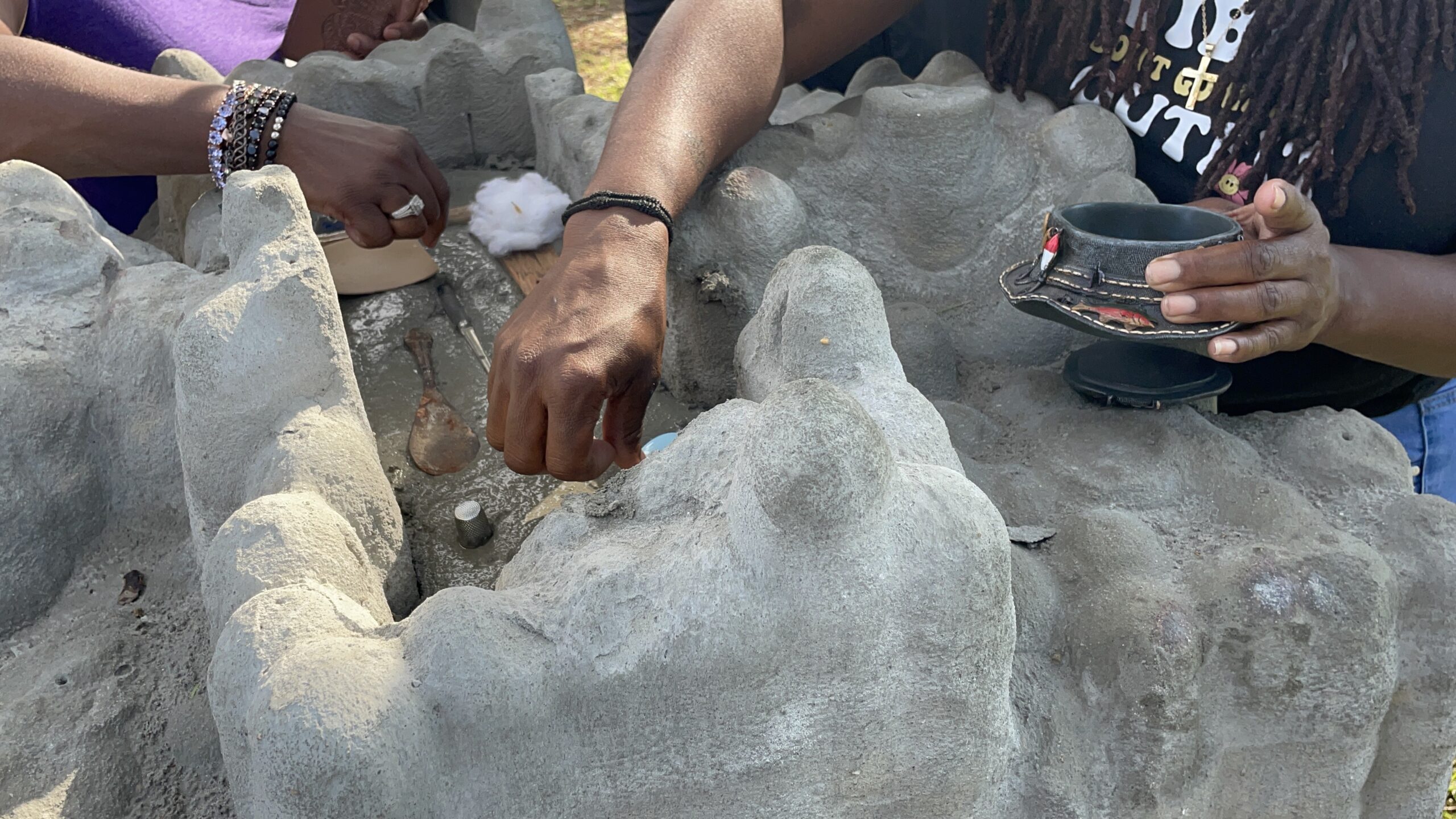 Family members placing an aquatic urn into a memorial marker